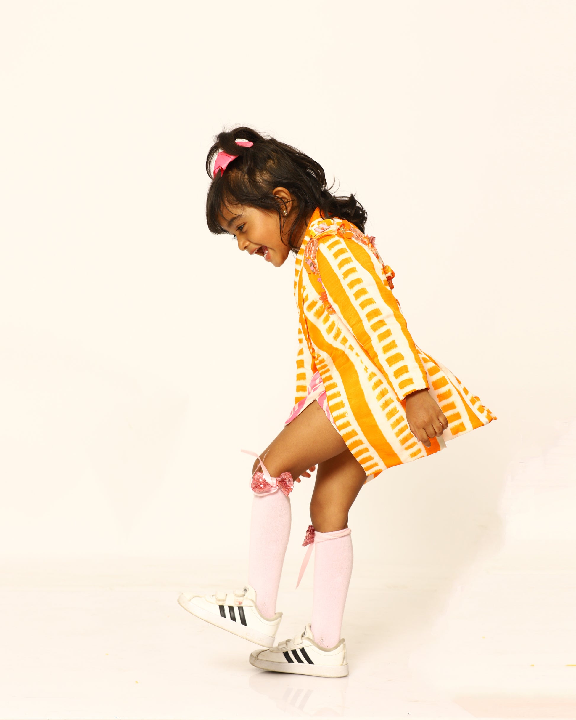 orange + candy + blazer + striped + flowers + pink + striped + skort + bow + socks + shoe + party + cheerful + jump + side
